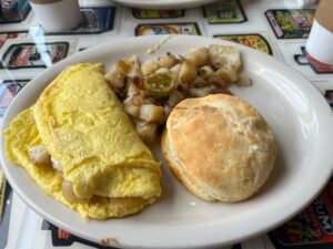 Bacon & Cheese Omelet with a side of potatoes